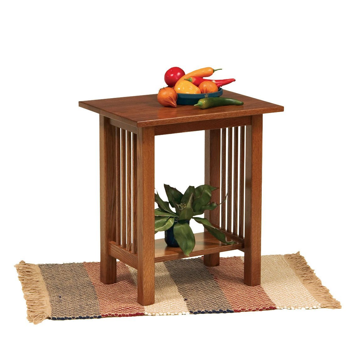 Small oak Mission end table with vertical slat sides and lower shelf, bowl of faux vegetables on top