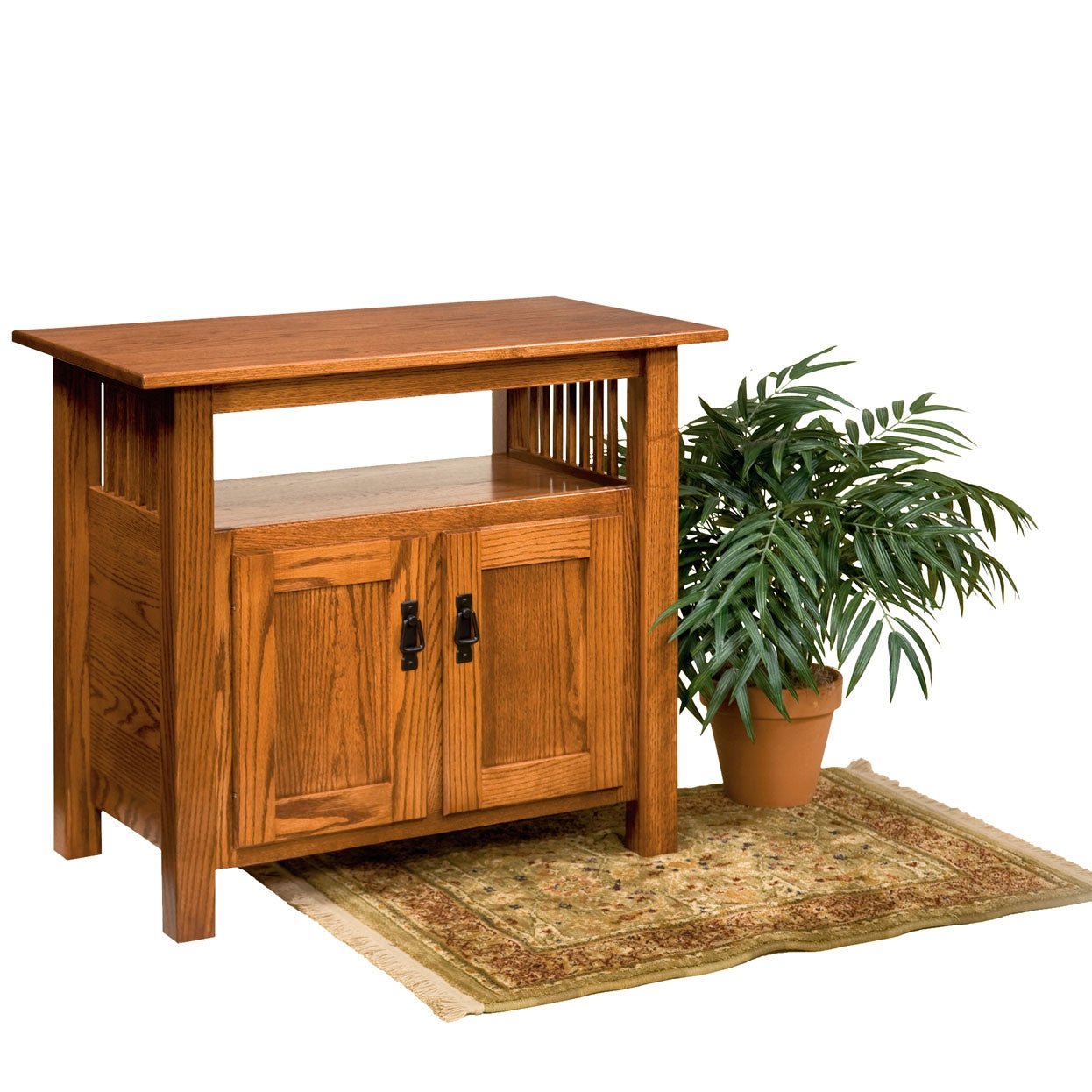 Oak Mission tv stand with an open center shelf holding books and two paneled doors with black hardware below