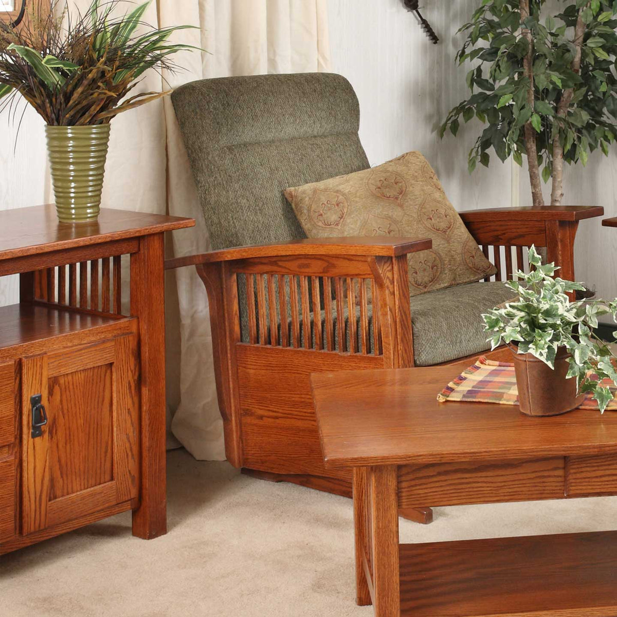 Oak Mission swivel chair with green cushions and slat sides beside a matching tv cabinet and coffee table