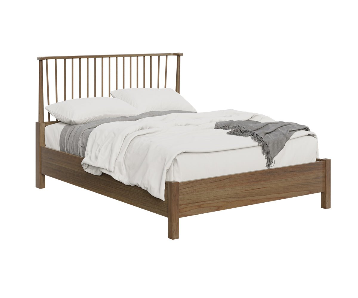Modern spindle Windsor bed in medium brown wood styled with gray bedding, telescope and dresser in a loft bedroom