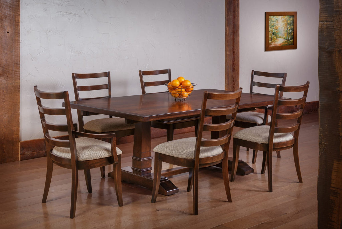 Dining set with a dark trestle table and six modern ladder back chairs with oatmeal seats in a beamed room