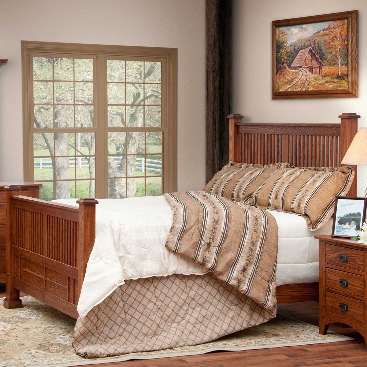 Mission oak spindle bed styled in a bedroom with striped pillows, framed barn artwork and a nightstand