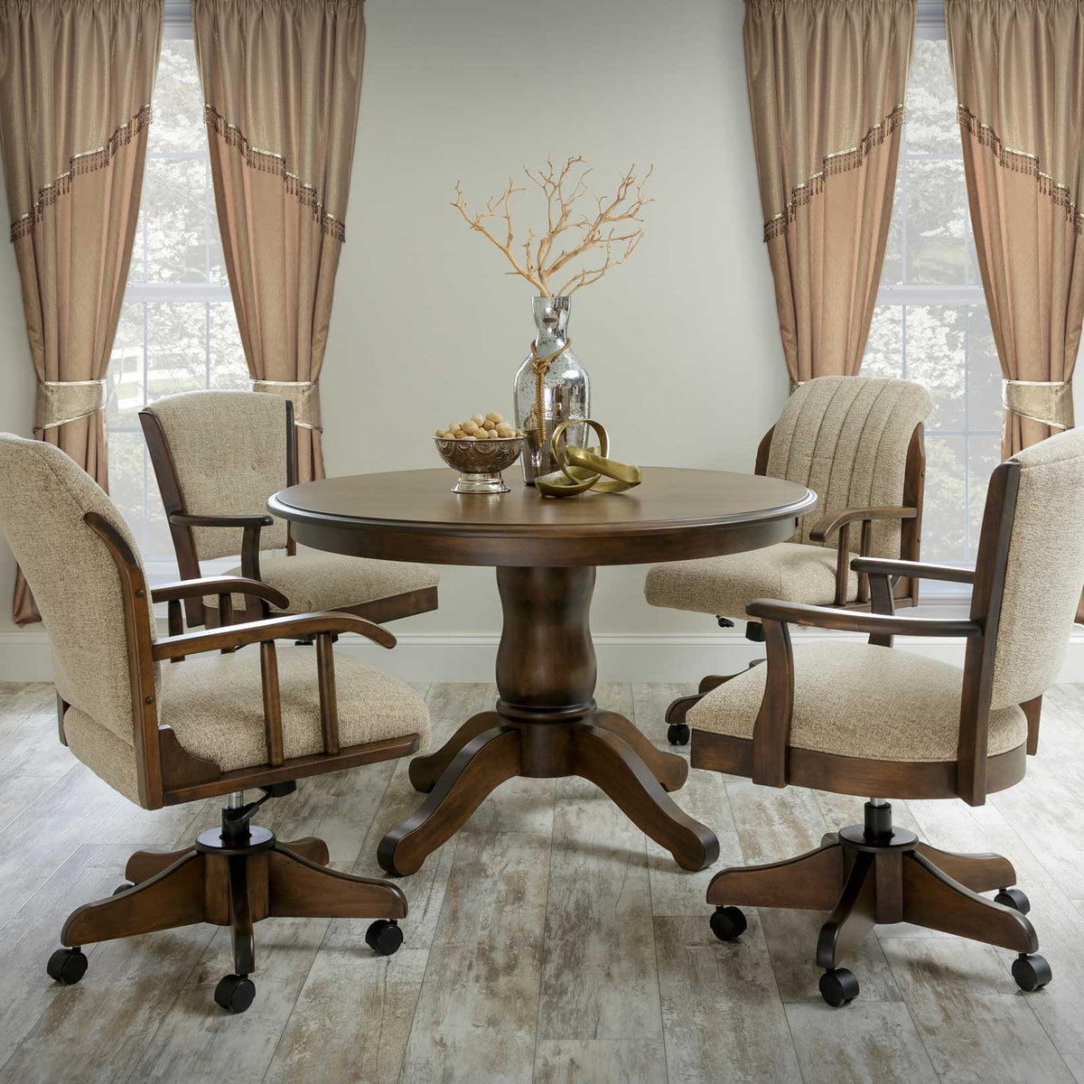 Round dark walnut pedestal table with four upholstered swivel caster chairs in a curtained dining room