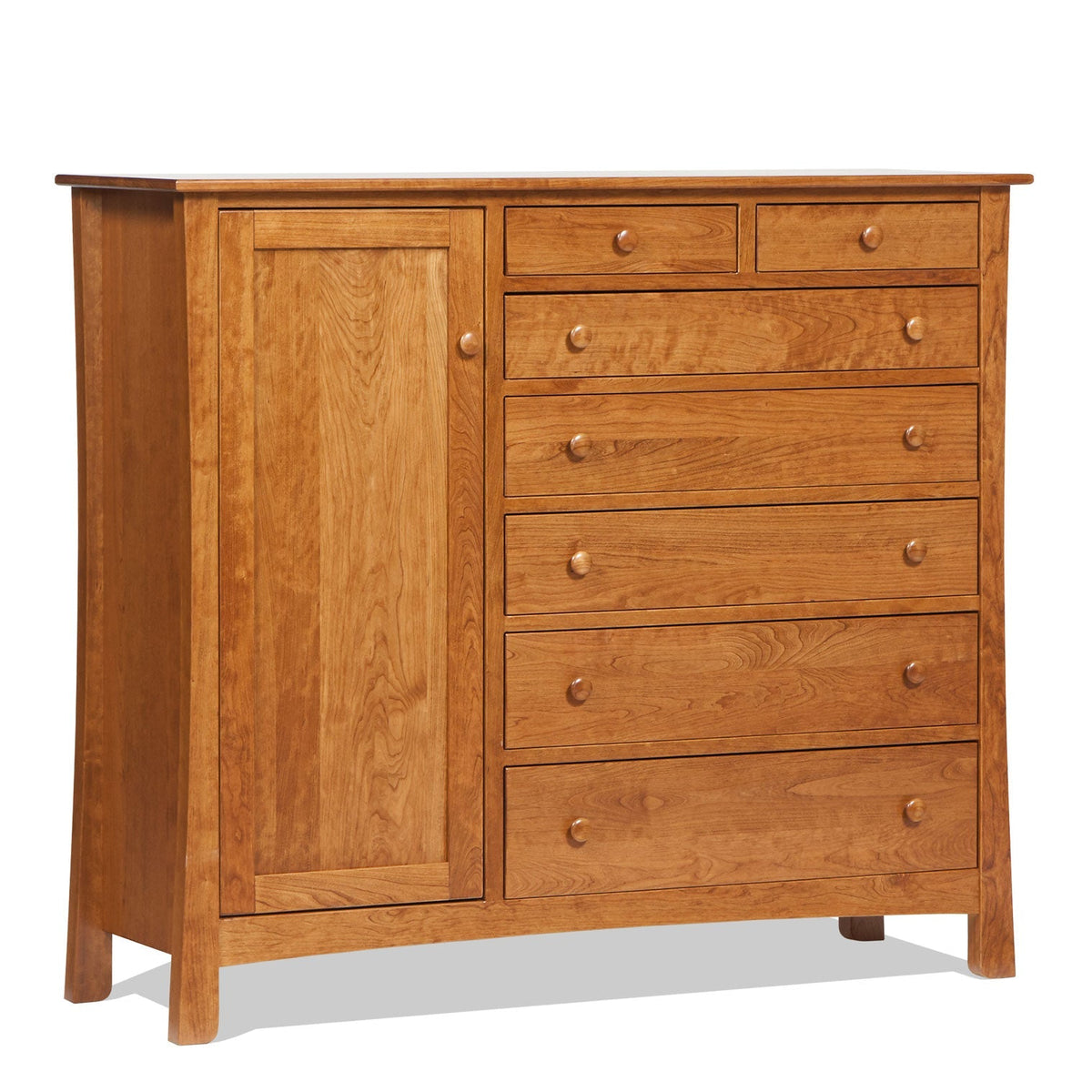 Cherry gentleman's chest with a tall paneled door beside seven knobbed drawers on flared legs