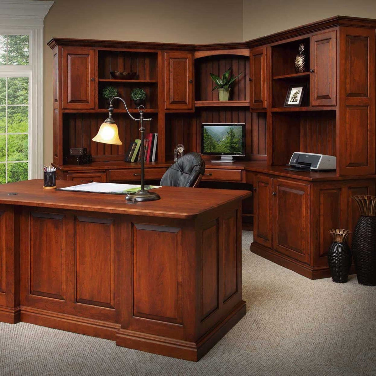Cherry executive office with a corner hutch workstation, printer cabinet and a large panel desk in the foreground
