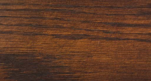 Coffee stain on oak wood sample showing warm amber brown color with bold dark oak grain lines