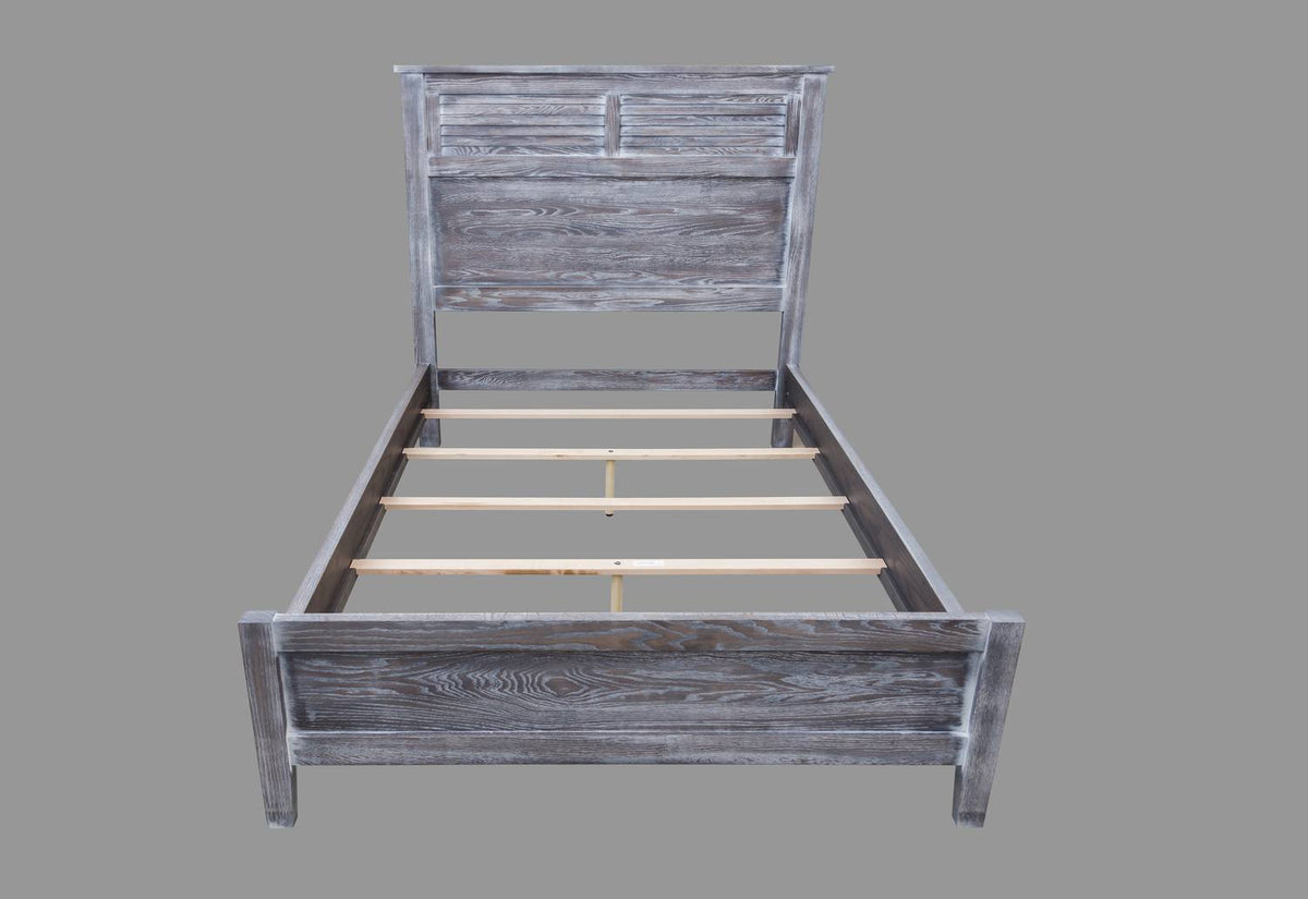 Front view of a gray oak louvered panel bed frame with slats in place and a low paneled footboard