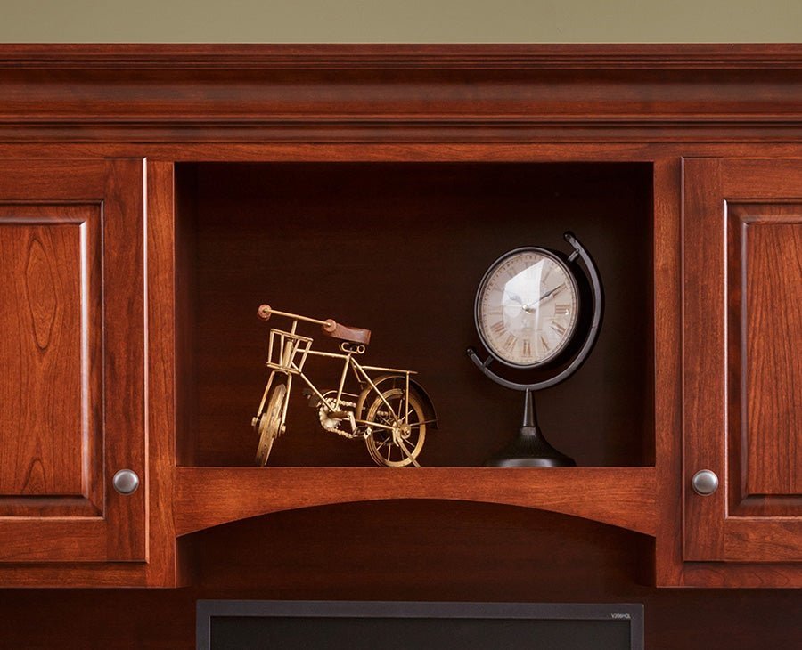Close look at the hutch center cubby with arched valance, raised panel doors and small round knobs