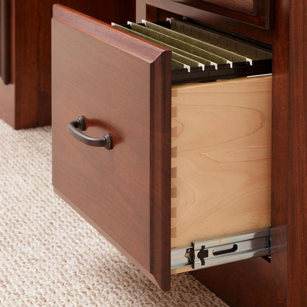 Cherry desk file drawer opened to reveal hanging file rails, dovetailed maple sides and a dark bail pull