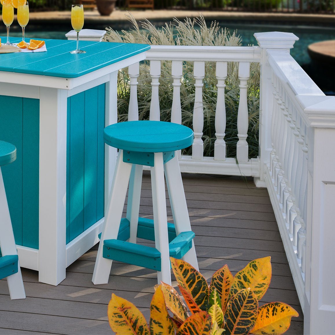 Turquoise and white poly swivel barstools with round seats and footrests beside a poolside patio bar