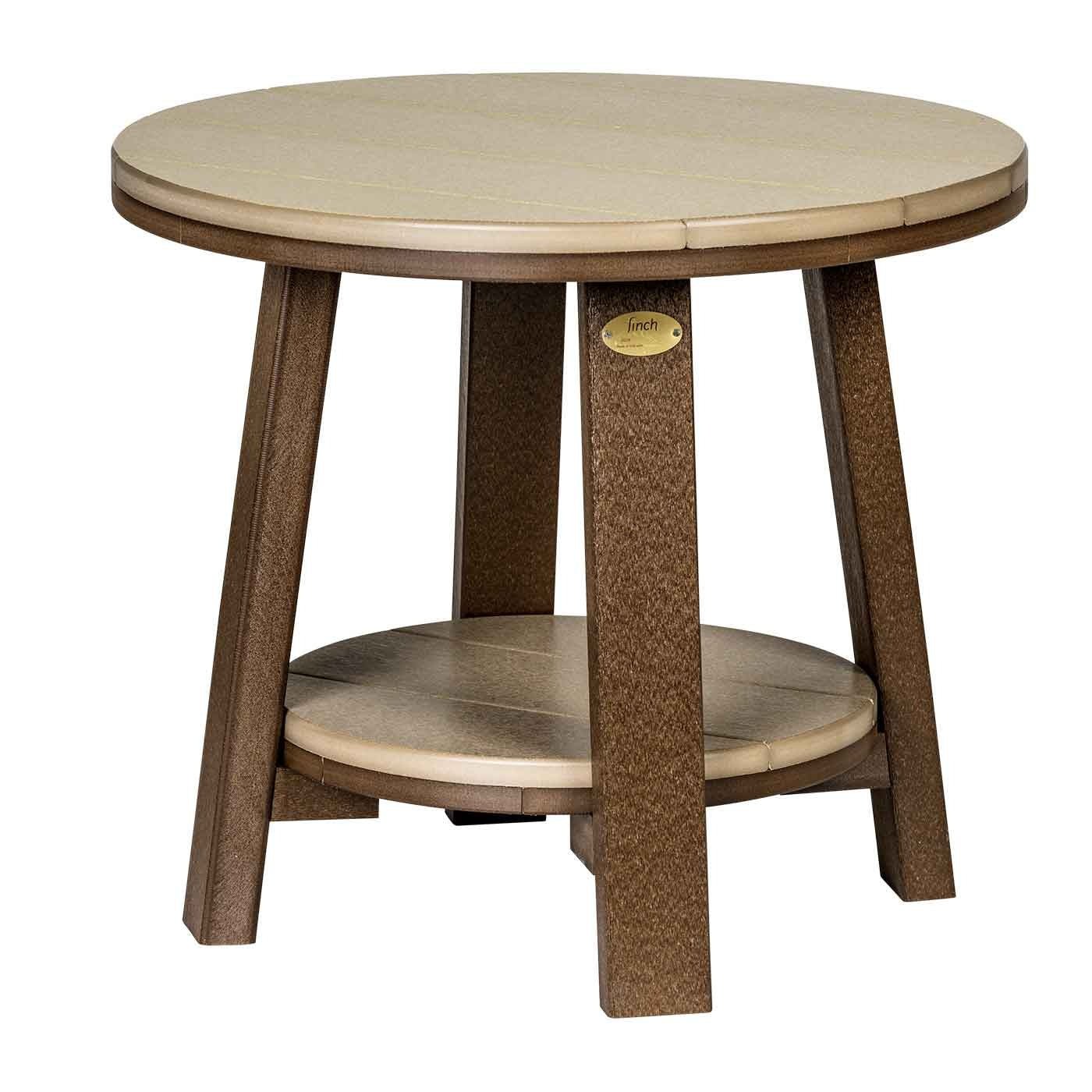 Round white and brown poly bistro table with a lower shelf between two Adirondack chairs on the beach
