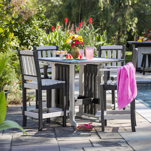 Black and light gray poly square bar height patio table with four tall slat back bar chairs beside a pool