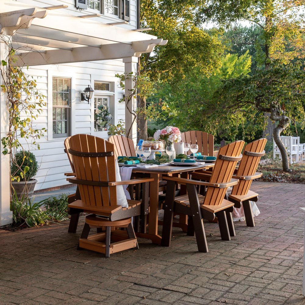 Cedar and brown poly 72 inch bistro patio dining table with six fan back swivel chairs set for dinner at dusk