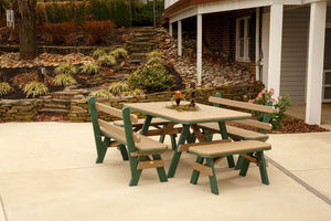 Cedar and green poly picnic table flanked by two backed garden benches on a concrete patio near a rock garden