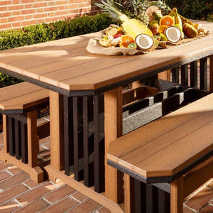 Close-up of a cedar and black poly mission patio table set with matching backless benches and a tropical fruit display on a brick patio