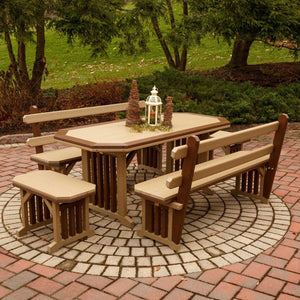 Weathered wood and brown poly patio table with bordered top and two matching benches with backs on a circular paver patio