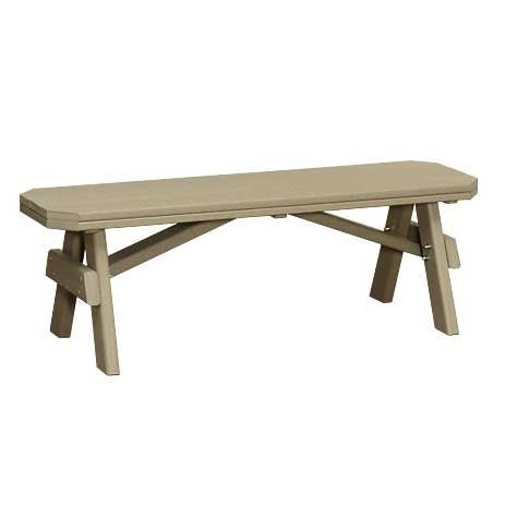 Cedar and green poly garden benches paired with a matching picnic table on a concrete patio by rose bushes