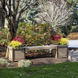 Weatherwood and brown poly planter bench with two square planter boxes of colorful foliage under a tree