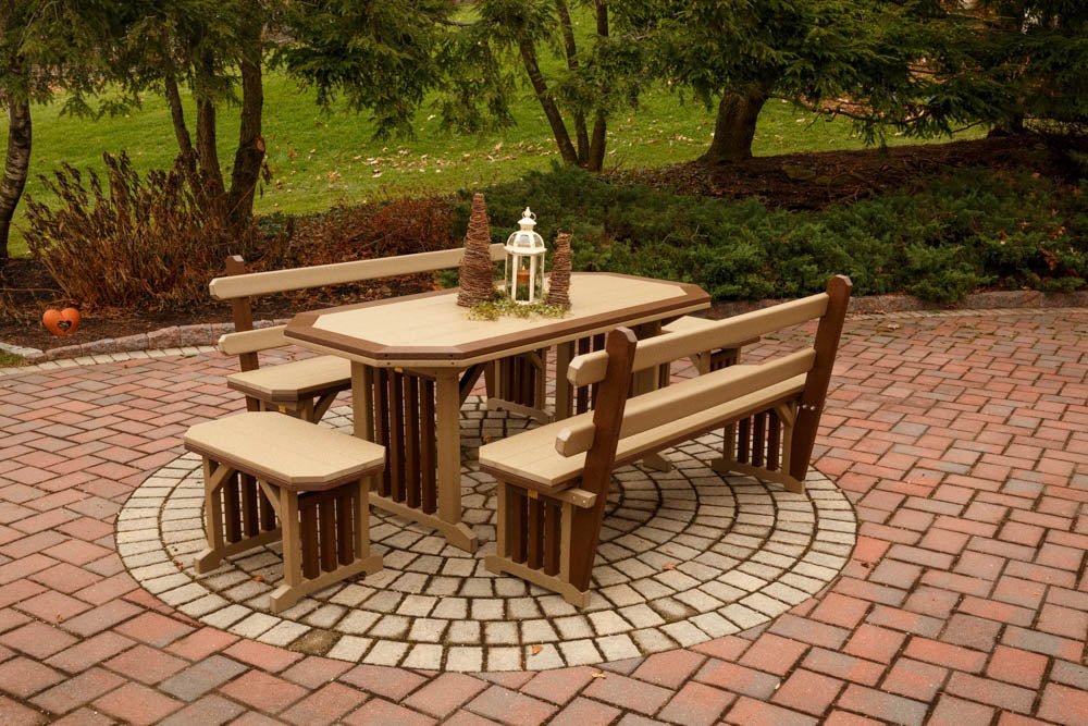 Weatherwood and brown Mission poly table with four backed benches on a circular brick paver patio