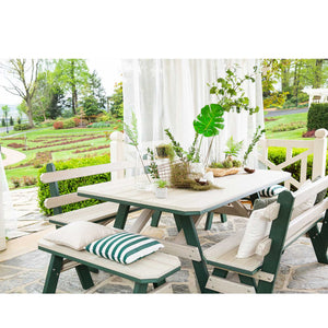 Driftwood and green poly garden table with a backed bench and two backless benches with striped pillows on flagstone