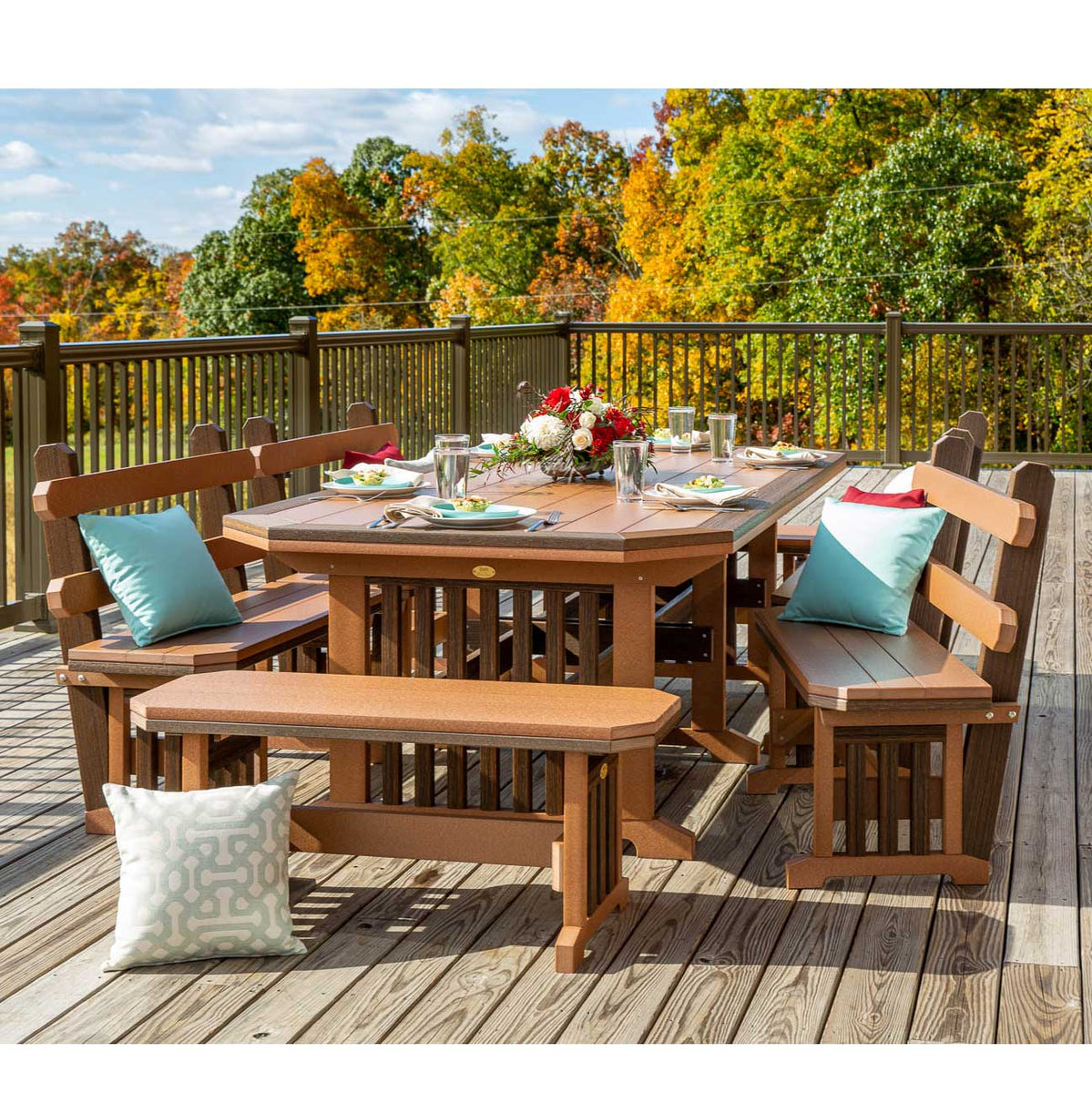 Antique mahogany Mission poly dining table with backed and backless benches set for six on a wooded deck