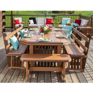 Overhead view of the brown Mission poly dining set with six benches, teal pillows and a floral centerpiece