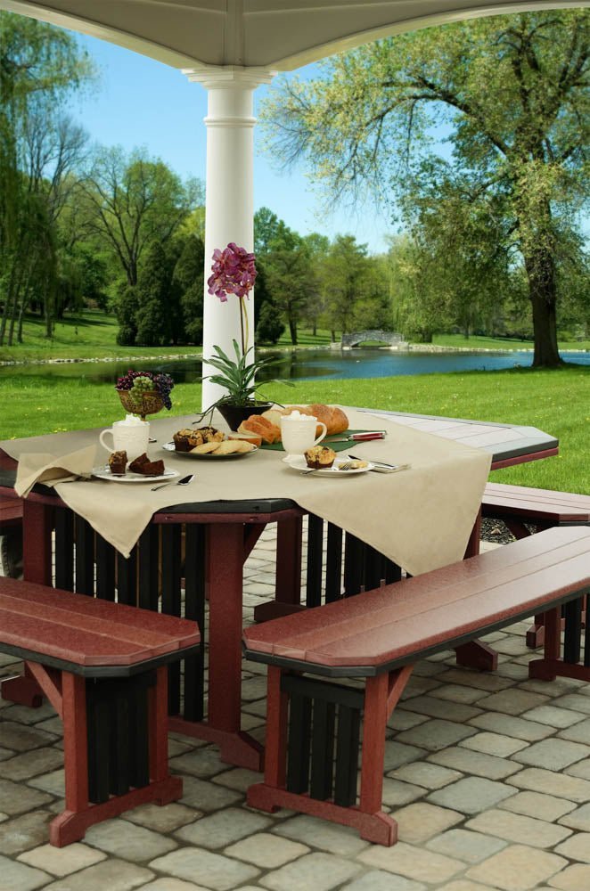 Cherrywood and black poly mission patio table set with four benches under a pavilion overlooking a pond
