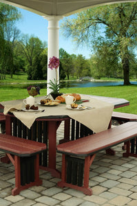 Cherrywood and black poly mission patio table set with four benches under a pavilion overlooking a pond