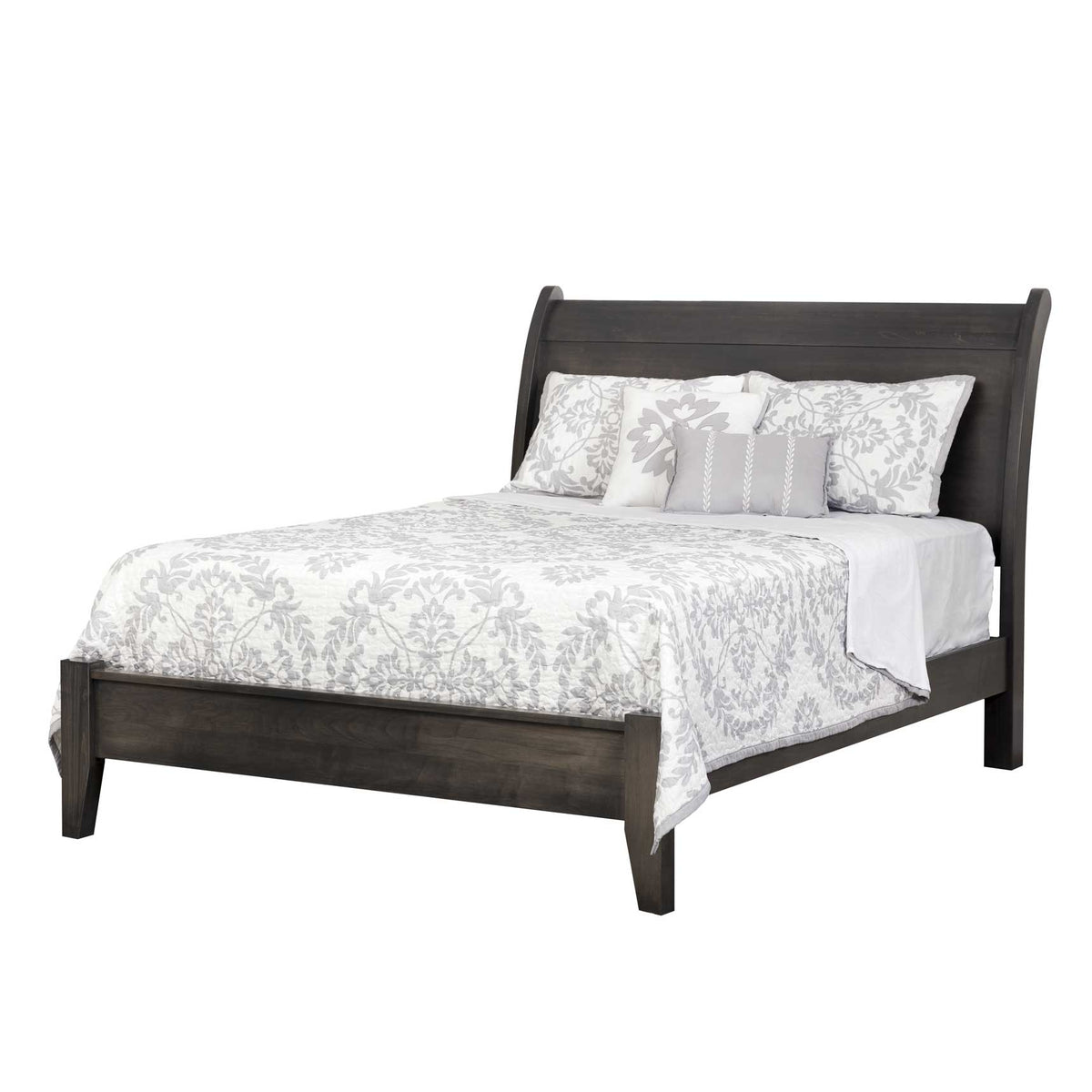 Weathered gray sleigh bed with a curved headboard, low panel footboard and tapered legs, styled with a gray floral quilt on white