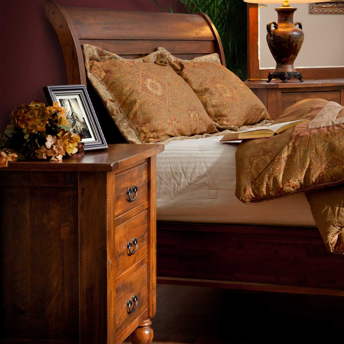 Queen sleigh bed in warm cherry with curved head and footboard panels, turned feet and white quilt