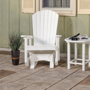 White poly Adirondack glider chair with fan back and wide arms on a stamped patio beside a round side table