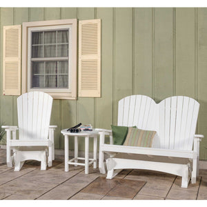 White poly Adirondack glider chair and two-seat glider bench with a round side table on a stamped concrete patio