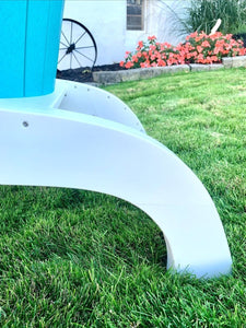 Close-up of the sculpted white curved base and stainless fasteners on a turquoise poly Adirondack perch chair