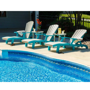 Driftwood and aruba blue chaise lounges and ottomans arranged along the curved concrete deck of a backyard pool