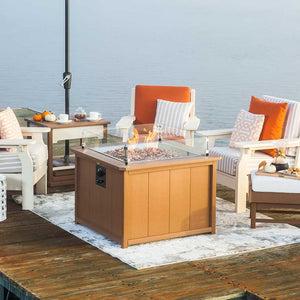 Cedar poly propane fire pit table with glass wind guard and side control knob on a waterfront dock