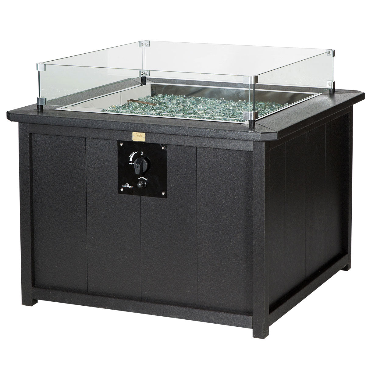 Square black poly propane fire pit table with a glass wind guard burning beside a cream cushioned sectional