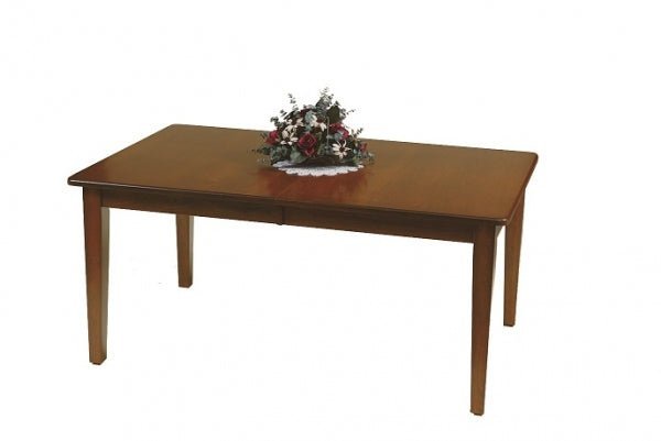 Cherry finished rectangular leg dining table with a smooth top and tapered legs, topped with a floral centerpiece