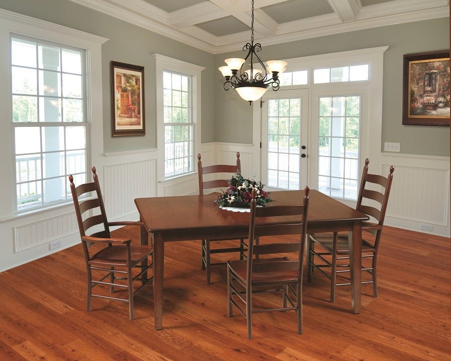 Cherry Shaker dining table with ladder back arm and side chairs in a sage green dining room with coffered ceiling and chandelier