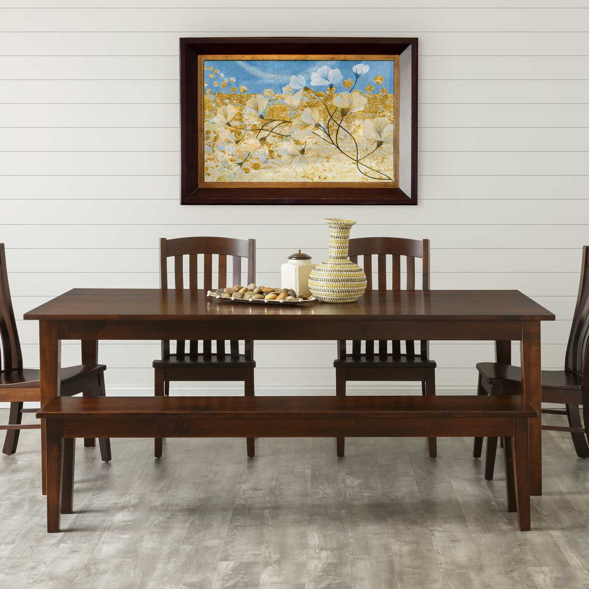 Espresso dining bench with a smooth seat and tapered legs pulled up to a matching dark Shaker table in a shiplap dining room