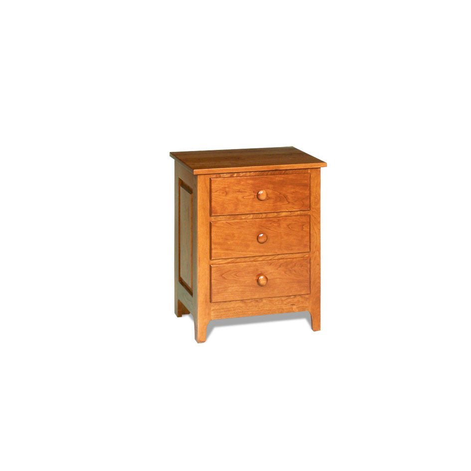 Three drawer cherry nightstand with round knobs under a lamp in a green painted bedroom