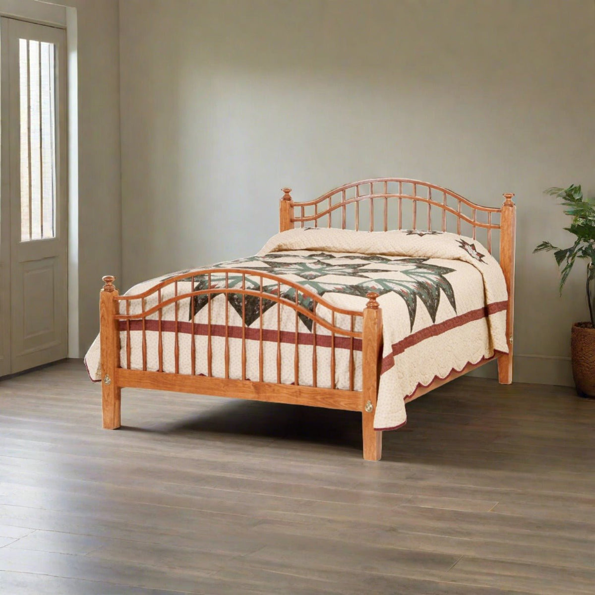 Cherry curved spindle bed with arched headboard and footboard rails and a star quilt in a bright room