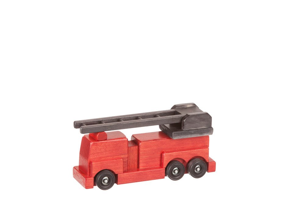 Family sitting on a rug playing with an assortment of wooden toy trucks, cars and a red fire engine