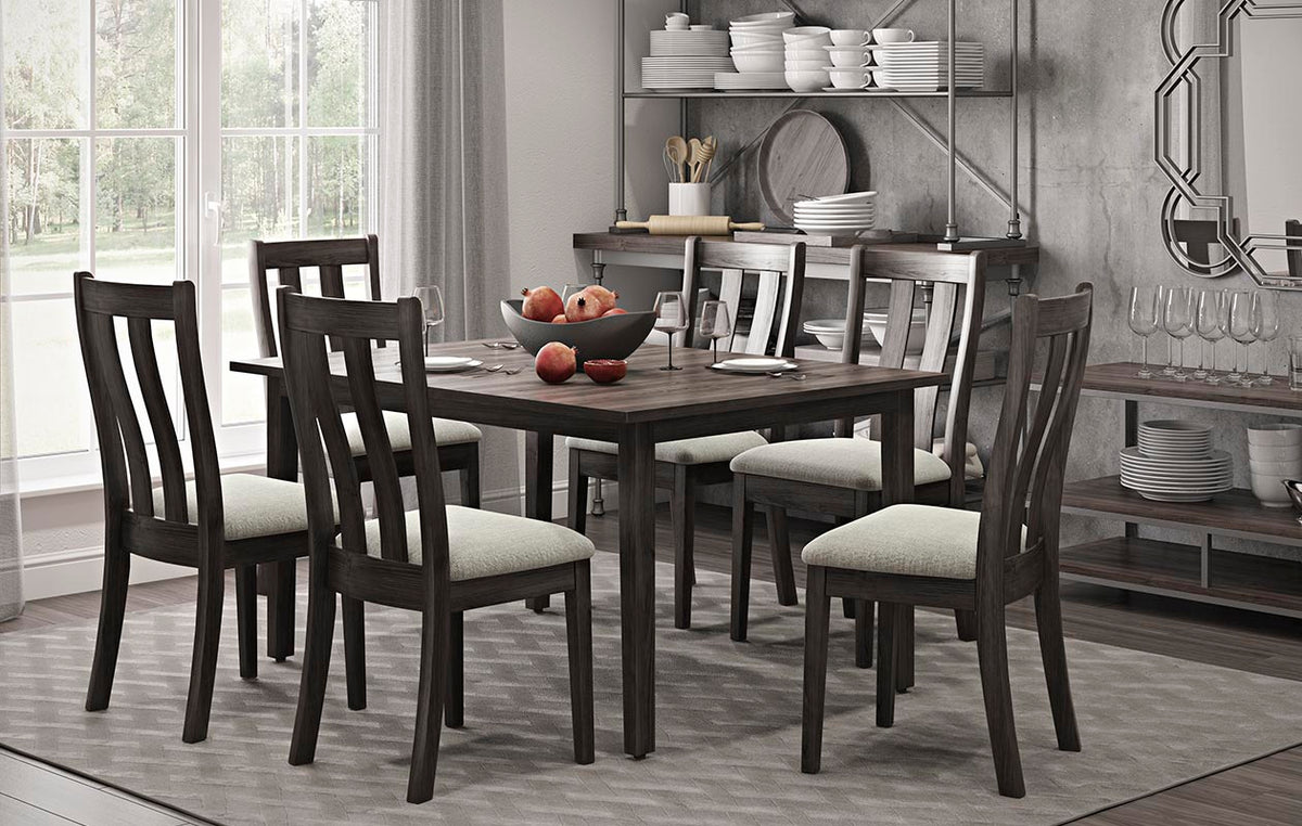 Charcoal dining set with rectangular table and six slat back chairs with light upholstered seats in a kitchen