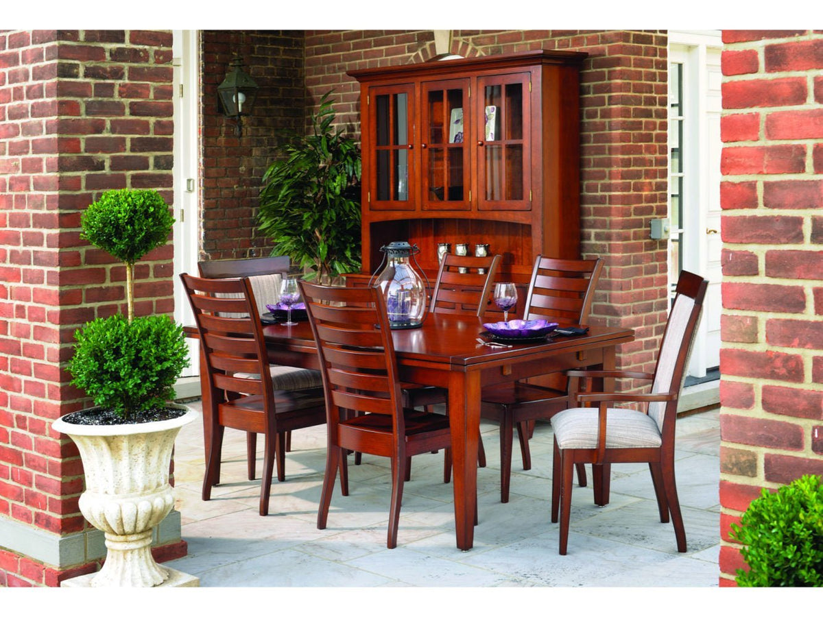 Cherry dining set with extension table, ladder back side and arm chairs and a lighted china cabinet outdoors