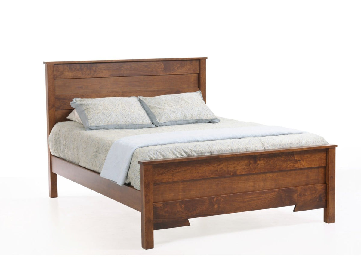 Cherry panel bed with a wide plank headboard and low footboard, dressed in pale blue and gray bedding