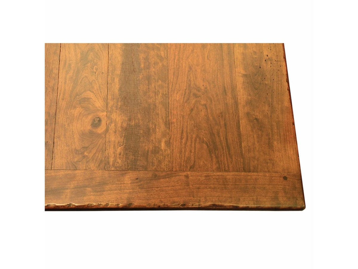 Corner view of a rustic cherry plank bench top showing wood grain, knots and a wavy live edge