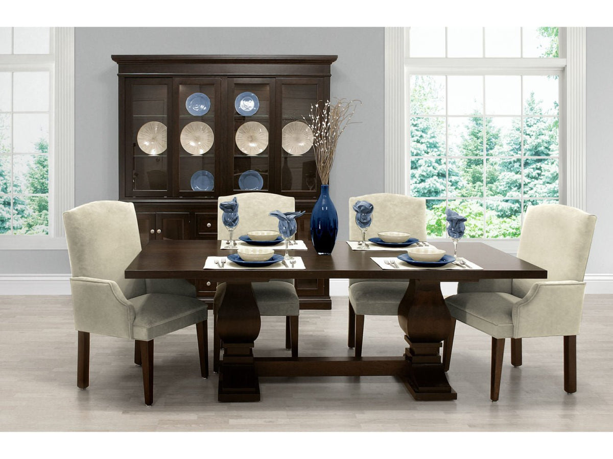 Espresso pedestal dining table set with four cream upholstered chairs and a lighted china cabinet