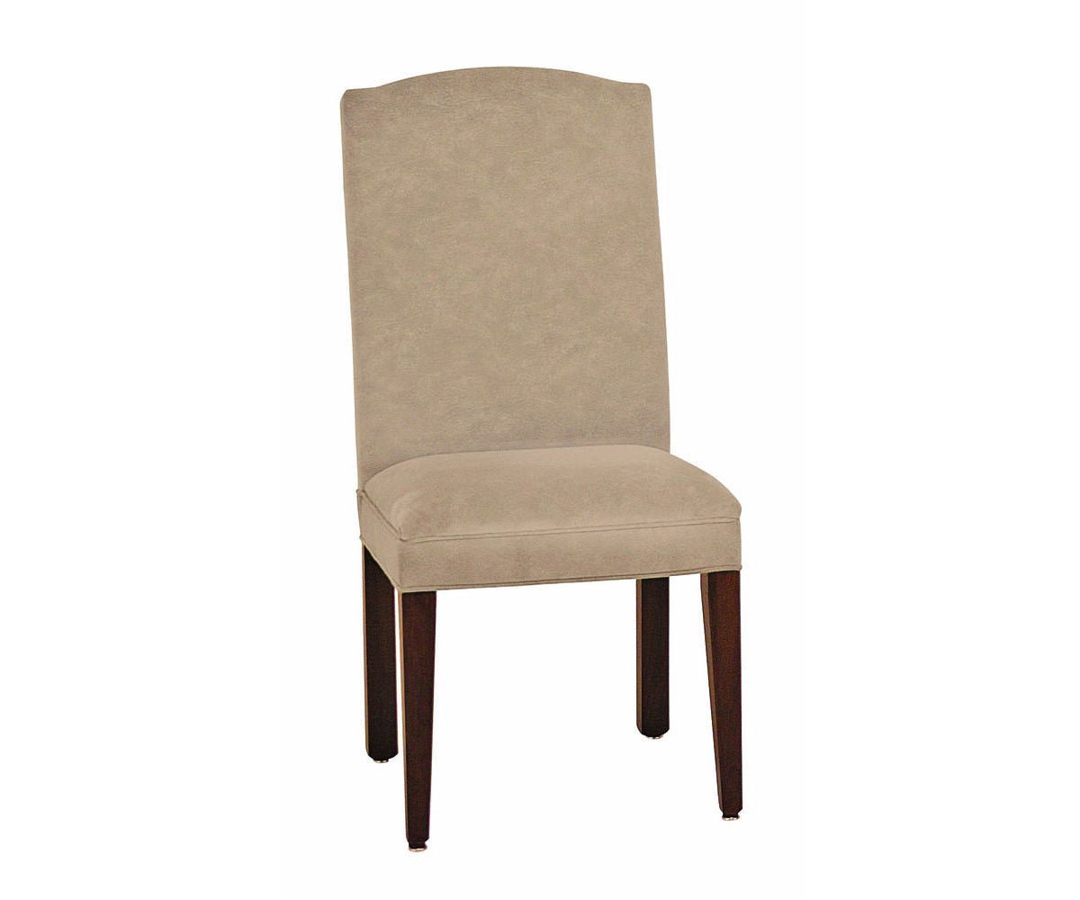 Cream upholstered dining side chair with a camel back, cushioned seat and dark tapered wood legs