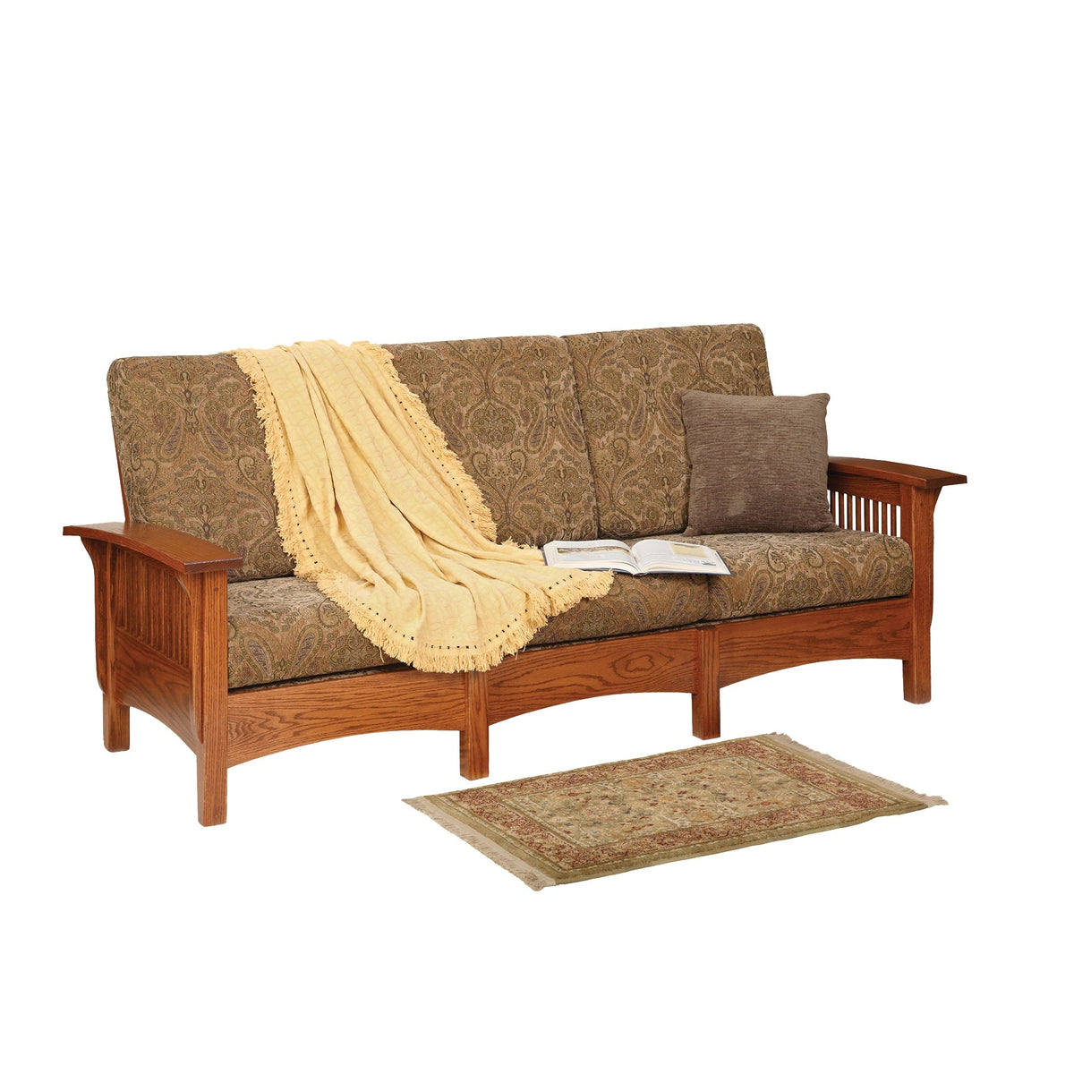 Oak Mission sofa with paisley tapestry cushions, slat sides and a fringed cream throw draped over the arm