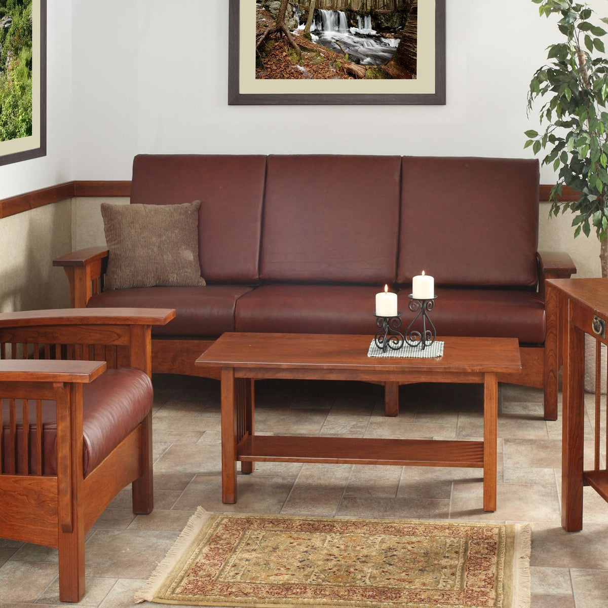 Cherry Mission Morris sofa with burgundy leather cushions, slat sides and a coffee table with candles in front